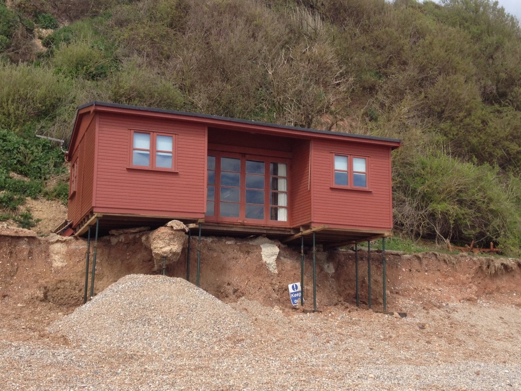 Storm damaged chalet on Branscombe beach