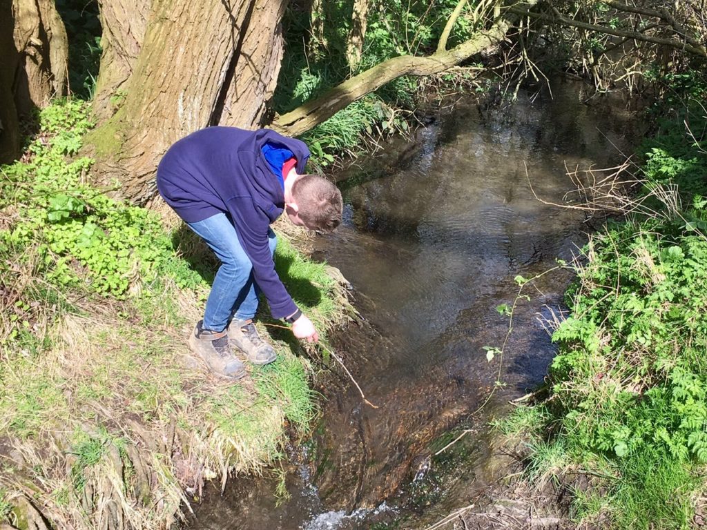 A boy, a stick and a stream!