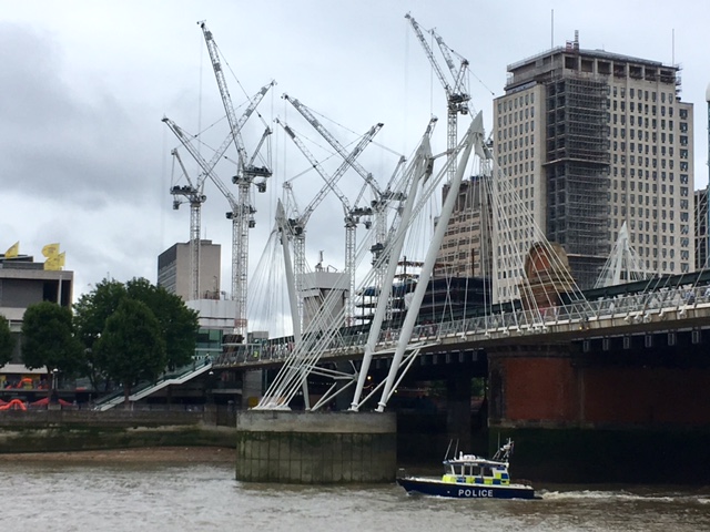 Cranes and a police boat, River Thames, London